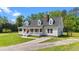 Charming home featuring a welcoming front porch, dormer windows, and a well-maintained front yard at 8700 Crowder Rd, Raleigh, NC 27603