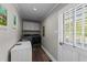 Convenient laundry room with a utility sink and modern appliances at 8700 Crowder Rd, Raleigh, NC 27603