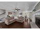 Open concept living room features a brick fireplace, hardwood floors, and easy access to the dining room at 8700 Crowder Rd, Raleigh, NC 27603