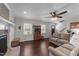 Relaxing living room with ceiling fan, brick fireplace, hardwood floors, and lots of natural light at 8700 Crowder Rd, Raleigh, NC 27603