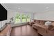 Cozy living room featuring hardwood floors, modern lighting, and windows at 8700 Crowder Rd, Raleigh, NC 27603