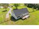 Rear view of house with fenced yard and wooden back deck with outdoor seating at 8700 Crowder Rd, Raleigh, NC 27603
