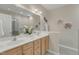 Bathroom with a double sink vanity, a neutral color palette, and decorative artwork at 9005 River Estates Dr, Knightdale, NC 27545
