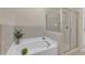 A luxurious soaking tub with separate glass enclosed shower at 9005 River Estates Dr, Knightdale, NC 27545