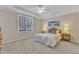 Bright bedroom with a tray ceiling, ceiling fan, large window, and soft, neutral colors at 9005 River Estates Dr, Knightdale, NC 27545