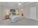 Bedroom featuring a tray ceiling, ceiling fan, neutral colors, and access to an ensuite bathroom at 9005 River Estates Dr, Knightdale, NC 27545