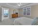 Primary bedroom with a ceiling fan, access to a living room, and large window at 9005 River Estates Dr, Knightdale, NC 27545