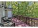 Private home deck showcasing comfortable seating and lush, serene wooded views at 9005 River Estates Dr, Knightdale, NC 27545