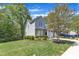 Charming two-story home with landscaped yard and mature trees on a sunny, partly cloudy day at 9005 River Estates Dr, Knightdale, NC 27545