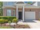 Charming front entrance with manicured shrubs and colorful flowers along the sidewalk at 9005 River Estates Dr, Knightdale, NC 27545