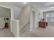 Hallway leads to room with wooden desk and carpeted floors at 9005 River Estates Dr, Knightdale, NC 27545