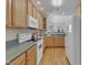 Traditional kitchen with wood cabinets, updated appliances, and hardwood floors overlooking the adjacent rooms at 9005 River Estates Dr, Knightdale, NC 27545