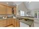 Cozy kitchen with wood cabinets, stainless steel sink, and open view to the living area at 9005 River Estates Dr, Knightdale, NC 27545