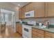 Traditional kitchen with wood cabinets, white appliances, and hardwood floors at 9005 River Estates Dr, Knightdale, NC 27545