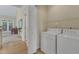Bright laundry room with white washer and dryer adjacent to the kitchen at 9005 River Estates Dr, Knightdale, NC 27545