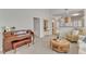 Open-concept living room with piano, neutral walls, coffee table, and access to the kitchen at 9005 River Estates Dr, Knightdale, NC 27545