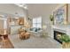 Comfortable living room with a fireplace, ceiling fan, a view of the kitchen, and an inviting seating area at 9005 River Estates Dr, Knightdale, NC 27545