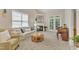 Cozy living room with a fireplace, plush seating, and bright windows for a relaxing space at 9005 River Estates Dr, Knightdale, NC 27545