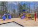 Community playground featuring colorful slides, climbing structure, and wood chip ground cover at 9005 River Estates Dr, Knightdale, NC 27545