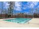 Community pool with marked swim lanes and a ladder entrance against a backdrop of tall trees at 9005 River Estates Dr, Knightdale, NC 27545
