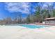 Community pool featuring several swimming lanes and a covered lounge area against a blue, partly cloudy sky at 9005 River Estates Dr, Knightdale, NC 27545