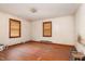 Bedroom with wood floors, two windows and outdated walls at 903 Creech Rd, Garner, NC 27529