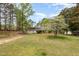 Charming home with brick accents and a serene front yard with mature trees providing ample shade at 903 Creech Rd, Garner, NC 27529