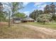 Lovely house with a classic brick facade, accented by a charming front porch and mature trees at 903 Creech Rd, Garner, NC 27529