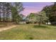 Charming home featuring a lush, vibrant front yard under a soft, colorful twilight sky at 903 Creech Rd, Garner, NC 27529
