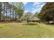 Charming single-story brick home featuring a welcoming front porch and a beautiful flowering tree at 903 Creech Rd, Garner, NC 27529