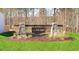 Welcoming community entrance with stone pillars, wood signage, and manicured landscaping at 102 Red Maple St, Sanford, NC 27332