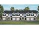 Charming townhouse exterior featuring stone accents, attached garages, and manicured landscaping at 102 Red Maple St, Sanford, NC 27332