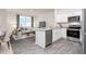 Open-concept kitchen featuring white cabinets, granite countertops, and stainless steel appliances at 102 Red Maple St, Sanford, NC 27332