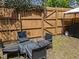A fenced backyard sitting area featuring patio chairs and a fire pit, perfect for outdoor gatherings at 1020 Randolph Ct, Cary, NC 27511