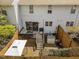 A cozy backyard with a wooden deck, patio seating, fenced perimeter, and a charming white house exterior at 1020 Randolph Ct, Cary, NC 27511