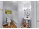 Well-lit bathroom featuring modern fixtures, hardwood floors, and a colorful art piece at 1020 Randolph Ct, Cary, NC 27511