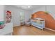 Inviting Bedroom with white crib, accent wall, and hanging plants at 1020 Randolph Ct, Cary, NC 27511