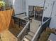 A backyard deck with patio seating and string lights, accessible via stairs from the yard and sliding glass door at 1020 Randolph Ct, Cary, NC 27511