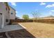 Spacious backyard with a wooden fence and concrete patio, providing a private outdoor space for leisure and activities at 1033 Laredo Ln, Durham, NC 27703