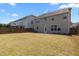 Expansive backyard surrounded by a wooden fence, featuring a patio and ample green space for recreation at 1033 Laredo Ln, Durham, NC 27703