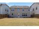 View of a fenced backyard with a patio and expansive lawn, ideal for outdoor entertainment and relaxation at 1033 Laredo Ln, Durham, NC 27703