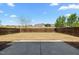 Large fenced-in backyard with grass and a concrete patio, perfect for outdoor activities and relaxation at 1033 Laredo Ln, Durham, NC 27703