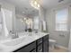 Bathroom featuring double sinks, a large mirror, and a window for natural light at 1033 Laredo Ln, Durham, NC 27703