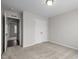 Carpeted bedroom features a closet and a view to another room at 1033 Laredo Ln, Durham, NC 27703