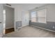 Cozy bedroom with light-colored walls and carpet, a closet, and natural light from windows at 1033 Laredo Ln, Durham, NC 27703