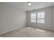 Well-lit carpeted bedroom features a window and neutral decor for a relaxing space at 1033 Laredo Ln, Durham, NC 27703