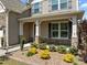Inviting porch featuring white columns with stone accents and colorful, well-maintained landscaping at 1033 Laredo Ln, Durham, NC 27703