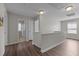 Upstairs hallway with wood flooring, natural light, and access to bedrooms and bathrooms at 1033 Laredo Ln, Durham, NC 27703