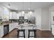 Bright kitchen featuring white cabinets, granite countertops, and stainless steel appliances with breakfast bar at 1033 Laredo Ln, Durham, NC 27703