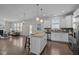 Open concept living featuring a kitchen with granite countertops and island flowing into the living room at 1033 Laredo Ln, Durham, NC 27703